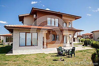 Suburban house with barbecue on backyard