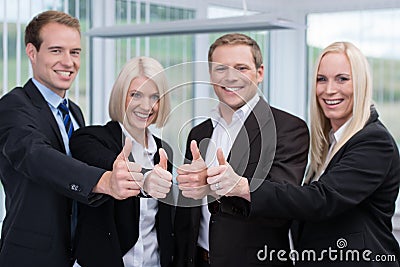 Successful business team giving a thumbs up