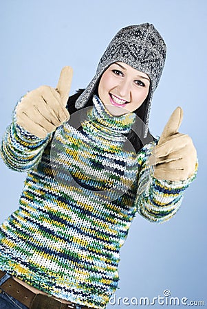 Successful girl in wool sweater give thumbs