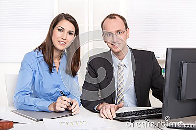 Successful teamwork - smiling man and woman in a blue blouse
