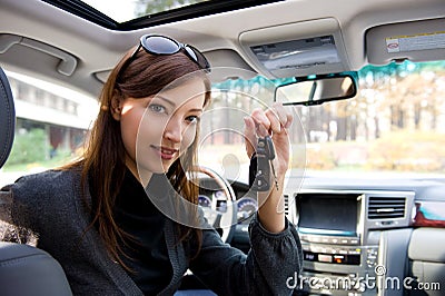 Successful woman with keys from car