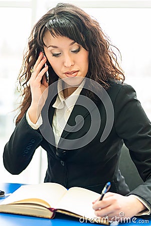 Successful business woman at office workplace with mobile cell phone