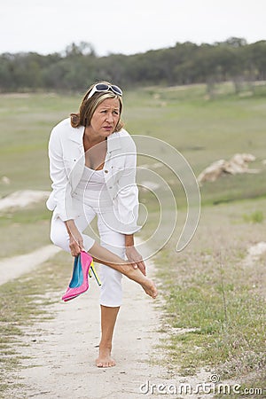 Suffering woman in high heels with sore feet