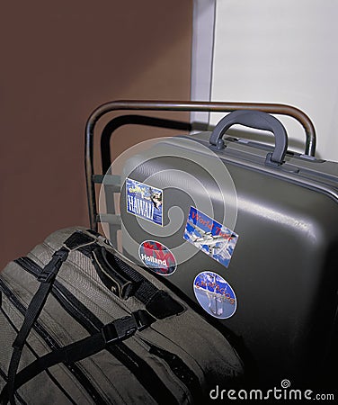 Suitcases with travel stickers on handc