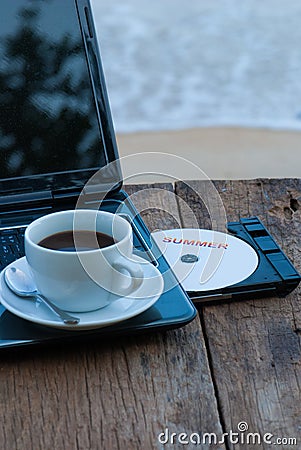 Summer concept with laptop and coffee cup