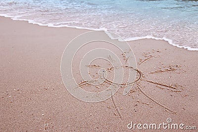 Sun drawn in the sand on the seashore