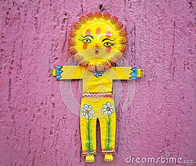 Sunflower figurine on a pink wall