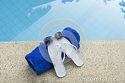 Sunglasses shoes towel pool blue water