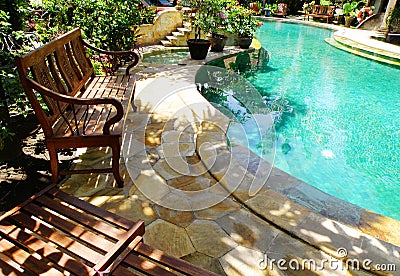 Sunny outdoor swimming pool and patio furniture