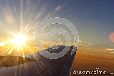 Sunset above wing of an airplane with Romantic sky