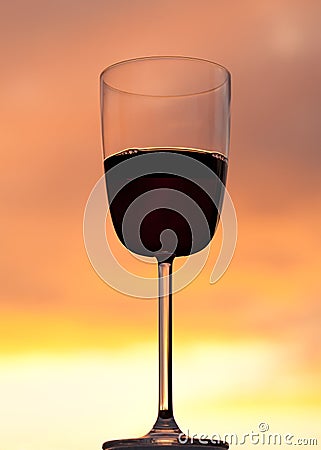 Sunset behind glass of red wine