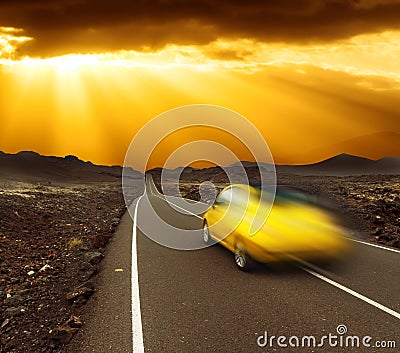 Sunset over fast car and road