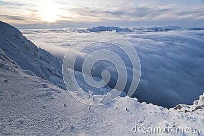 Sunset over the mountains and clouds in winter