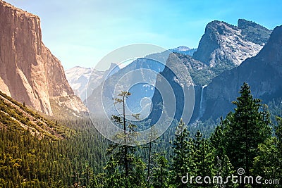 Sunset s golden light moves across Yosemite Valley s waterfalls