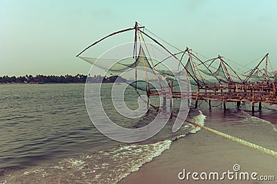 Sunset at tropical beach with chinese fishing nets