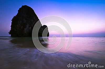 Sunset at tropical beach landscape. Ocean coast with rock format