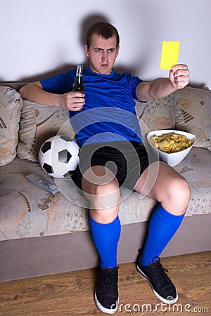 Supporter watching football on tv at home