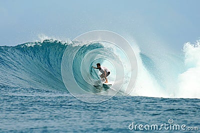 Surfer riding in barrel on perfect wave