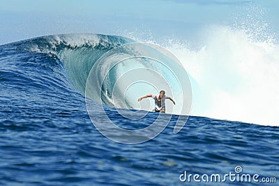 Surfer riding in barrel on perfect wave
