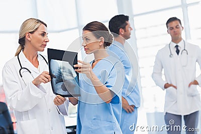 Surgeon and doctor analyzing x-ray together
