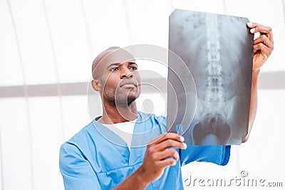 Surgeon examining X-ray image.