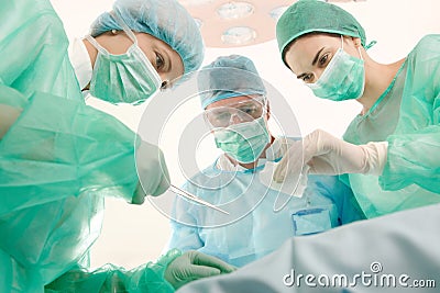 Surgeons and medical assistant operating