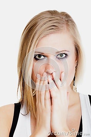 Surprised afraid girl covering mouth with hand