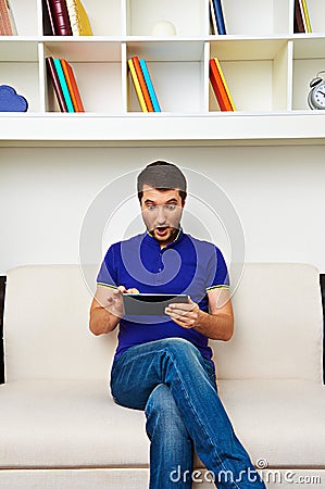 Surprised man looking at tablet pc