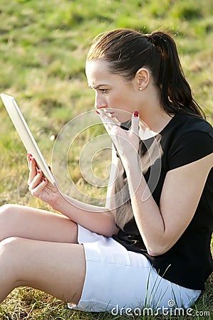 Surprised woman with tablet computer