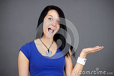 Surprised young woman holding something