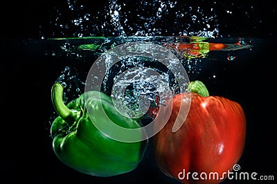 Sweet pepper drop into water on black background.