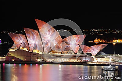 Sydney Opera House lit with vibrant colours and patterns during