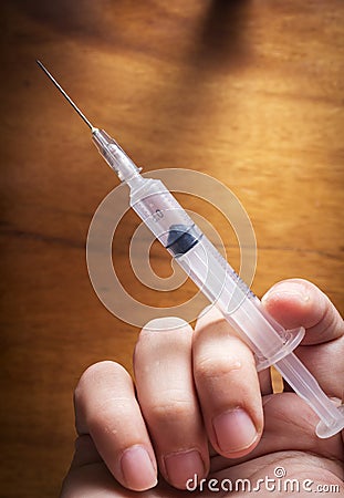 Syringe in human hand,medical concept.