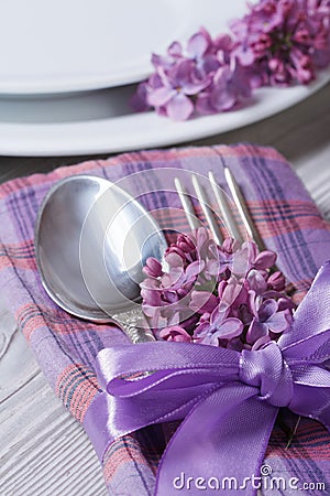 Table setting in violet colors, decoration flowers lilacs.