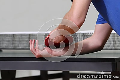 Table tennis player serving