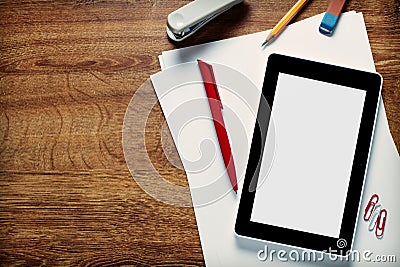 Tablet Computer and Supplies on Top of Wooden Desk