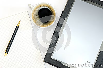 Tablet, notepad with a pen and a cup of coffee