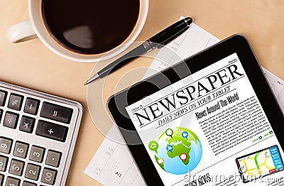 Tablet pc shows news on screen with a cup of coffee on a desk