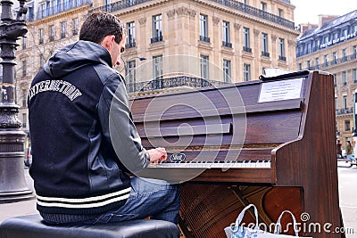 A talented homeless musician plays the piano in the street to earn some money