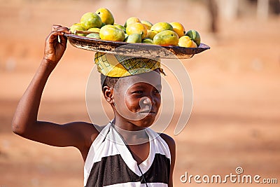TAMALE, GHANA � MARCH 22: Unidentified young african girl carry