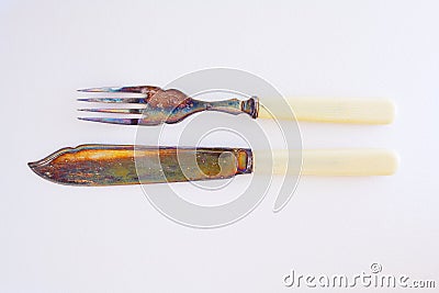 tarnished silver fish knife and fork tell of an earlier more refined