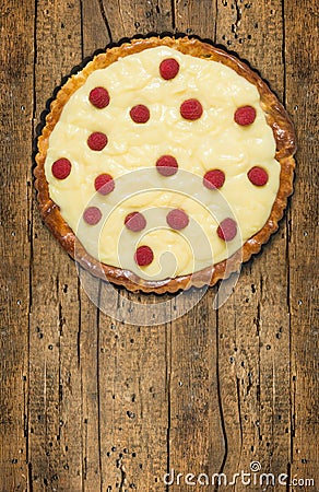 Tart with raspberries in baking dish, copy space