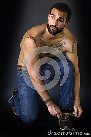 Tattooed Man tying his shoes