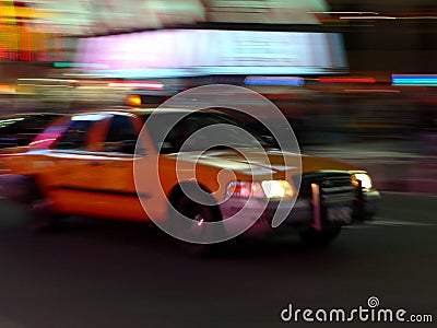 Taxi speeds down the street