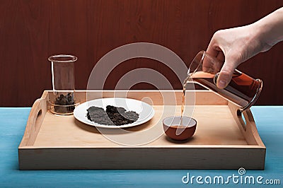 The tea ceremony: someone pours a cup of tea