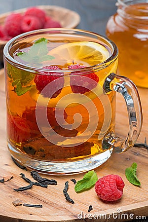 Tea with lemon, mint, raspberry and cinnamon, close-up