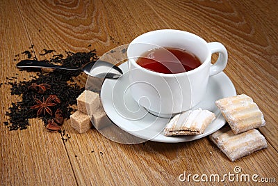 Tea in a white mug with cinnamon and cardamom