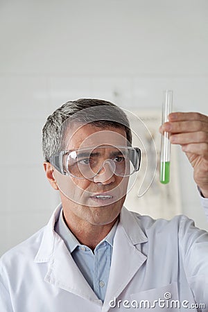 Teacher Analyzing Chemical Solution In Science Lab