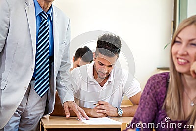 Teacher checking student work