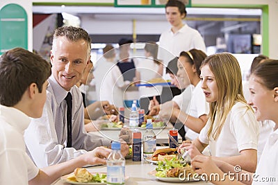 A teacher eating lunch with his students